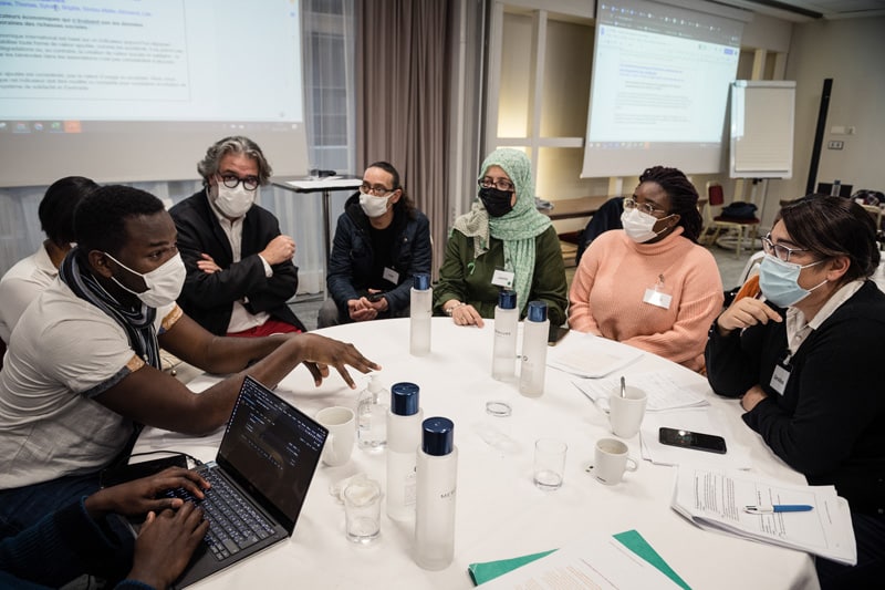 Conférence Citoyenne sur l'aide, l'entraide et les solidarités, 2021 - Photo d'ensemble d'une demi-douzaine de participants installés à une table ronde pour travailler et réfléchir ensemble